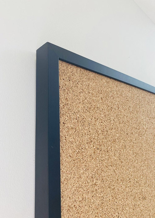 Black framed cork pin board