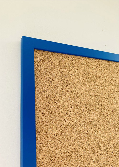 Blue framed cork pin board