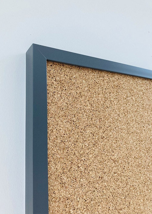 Dark grey framed cork pin board