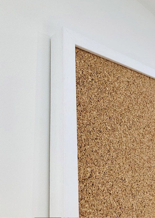 White framed cork pin board