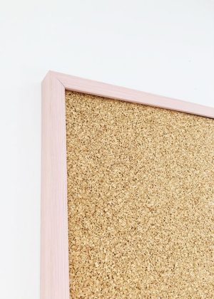 Pale pink framed cork pin board